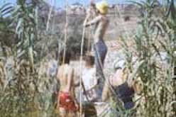 Several people building hut