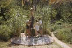 Several people building hut