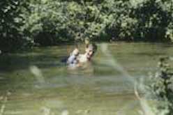 Person swimming in lake