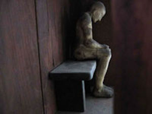 Detail of Man in Dwelling wall sculpture