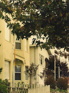 Housefront with trees in foregraound