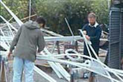 Several people making vertical sculptures